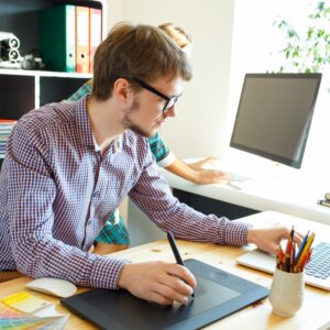 Young artist drawing something on graphic tablet