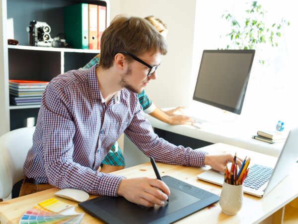 Young artist drawing something on graphic tablet